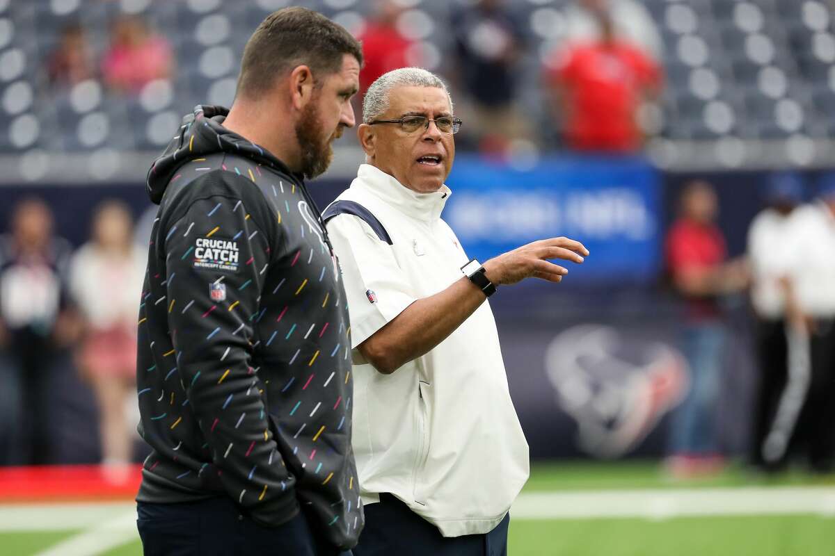 Houston Texans offensive coordinator Tim Kelly, left, and head coach David Culley talk while watching warm ups before an NFL football game against the New England Patriots Sunday, Oct. 10, 2021, in Houston.