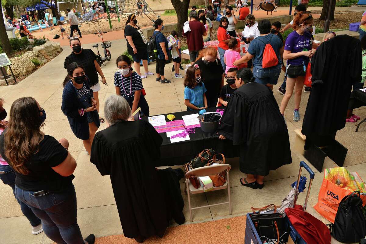 Judges talk with interested youngsters during the International Day of the Girl in the Alamo City on Sunday afternoon at Yanaguana Garden.