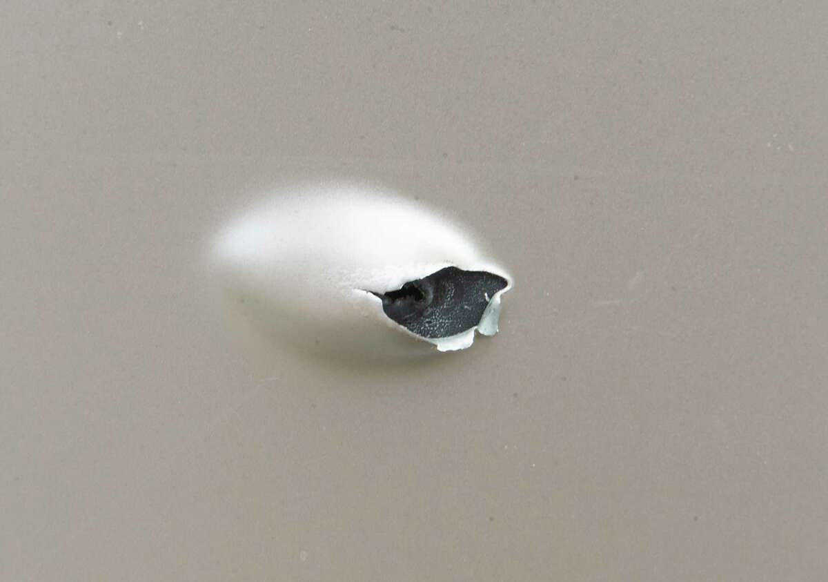 A bullet hole is seen on a building at the scene of Saturday night’s mass shooting that killed Alexander Bolton and wounded six people on Monday, Oct, 11, 2021 in Albany, N.Y. The shooting happened at the Lounge located at 117 North Lake Ave.