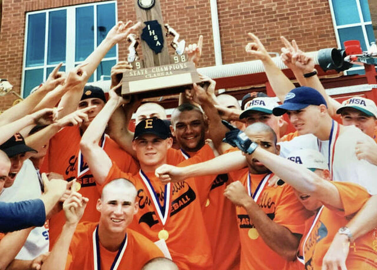 Chad Opel, center, holds the championship trophy after the Edwardsville Tigers won the Class AA state tournament in 1998.