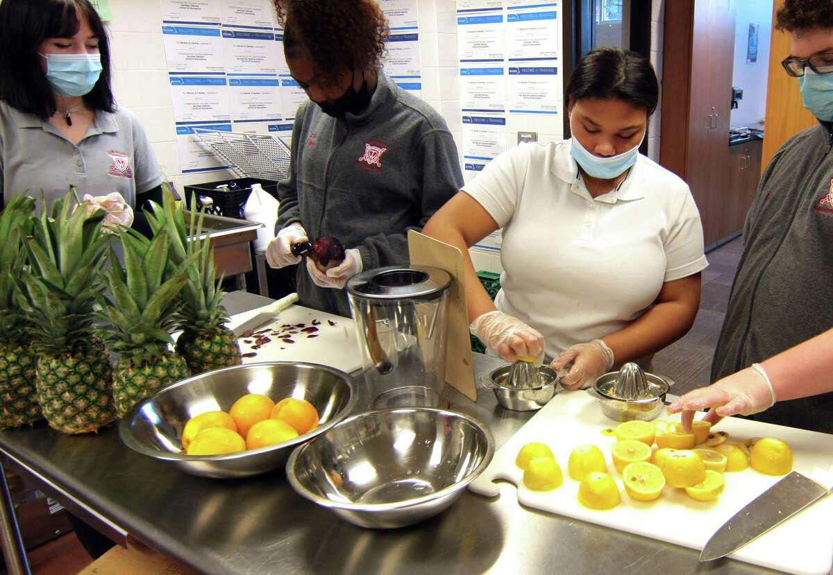 Wright Tech School student Tamara Hamilton, second from right, helps to make lemonade at The Wright Bean, a beverage program which operates every Friday at the school in Stamford. The program, which is part of the Hospitality Tourism & Guest Services, was launched in March of 2021, and provides students with hands on experience making and serving smoothies, milkshakes, as well as coffee and tea beverages.