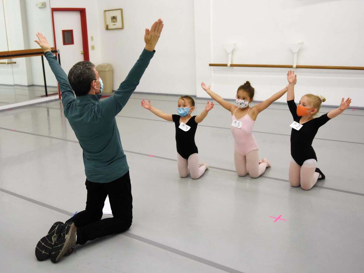 Above, artistic director and founder Brett Raphael leads 4-year-olds Isla McBeth, Karina Michalczyk and Sophie Micewicz through auditions for "The Nutcracker" at Connecticut Ballet in Stamford on Sunday. After a two-year hiatus due to COVID, "The Nutcracker" will return this year with performances on Dec. 18 and 19 at The Palace in Stamford. At right, Brett Raphael measures Giana James, 6, before her audition for "The Nutcracker" at Connecticut Ballet in Stamford. More photos inside on Page A4 or online at stamfordadvocate.com.