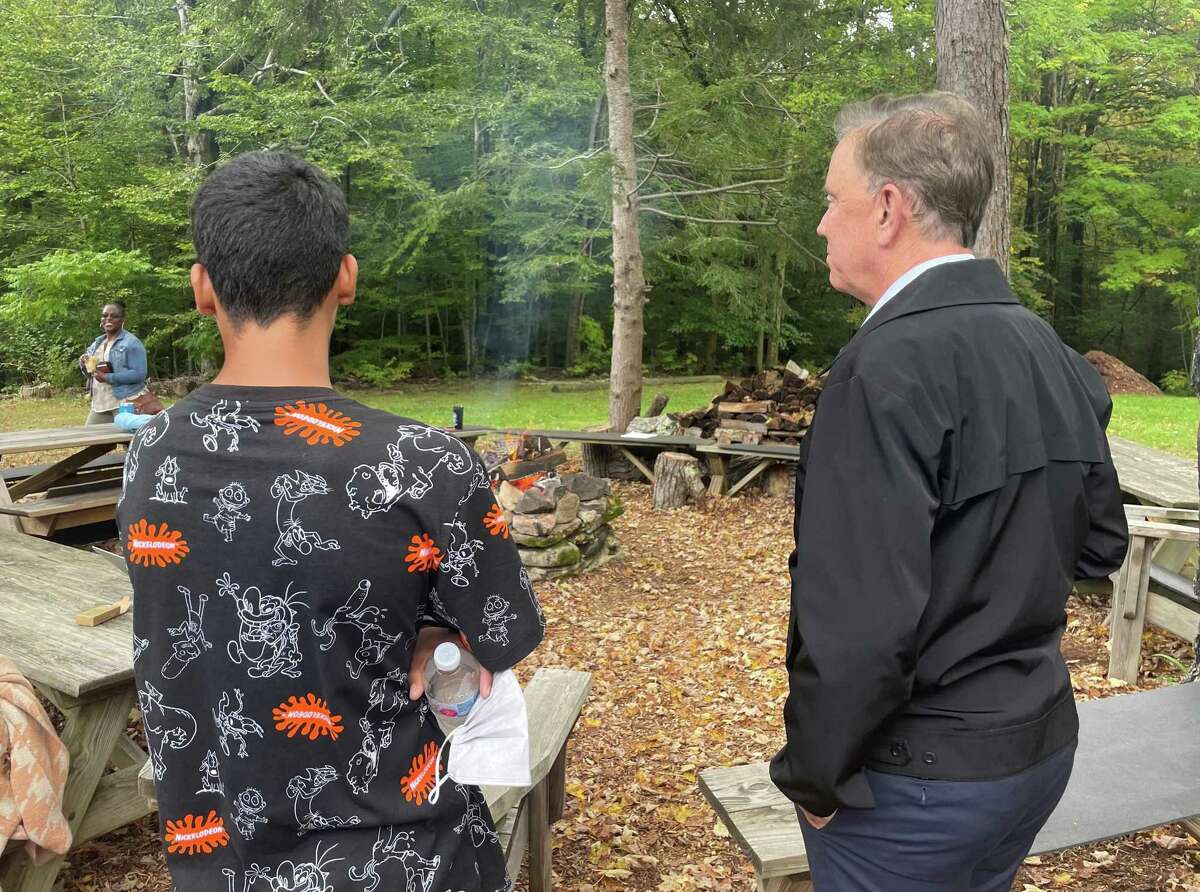 Gov. Ned Lamont made a visit last week to The Wilderness School, a program run by the state Department of Children and Families in East Hartland to help youths who are either in the criminal justice system or have suffered trauma that leaves them at risk. Lamont is pictured with a 17-year-old from the Hartford area in gathering area at the outdoor school.