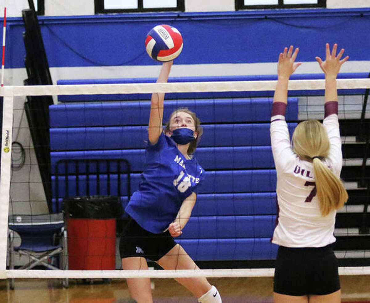 Marquette Catholic senior Natalie Wills (left) attacks during a match against EA-WR in the Roxana Tourney on Aug. 23. The Explorers were at home Monday night and defeated Okawville in three sets in Alton.