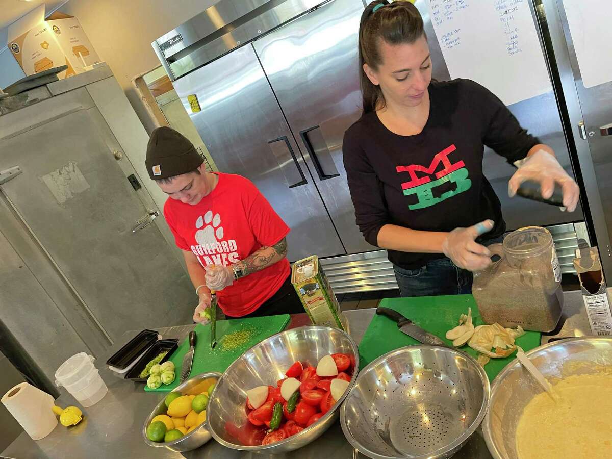 Working side by side in the Mama Basta prep area are from left, Hayley Wilmot and owner Nicole Ball.