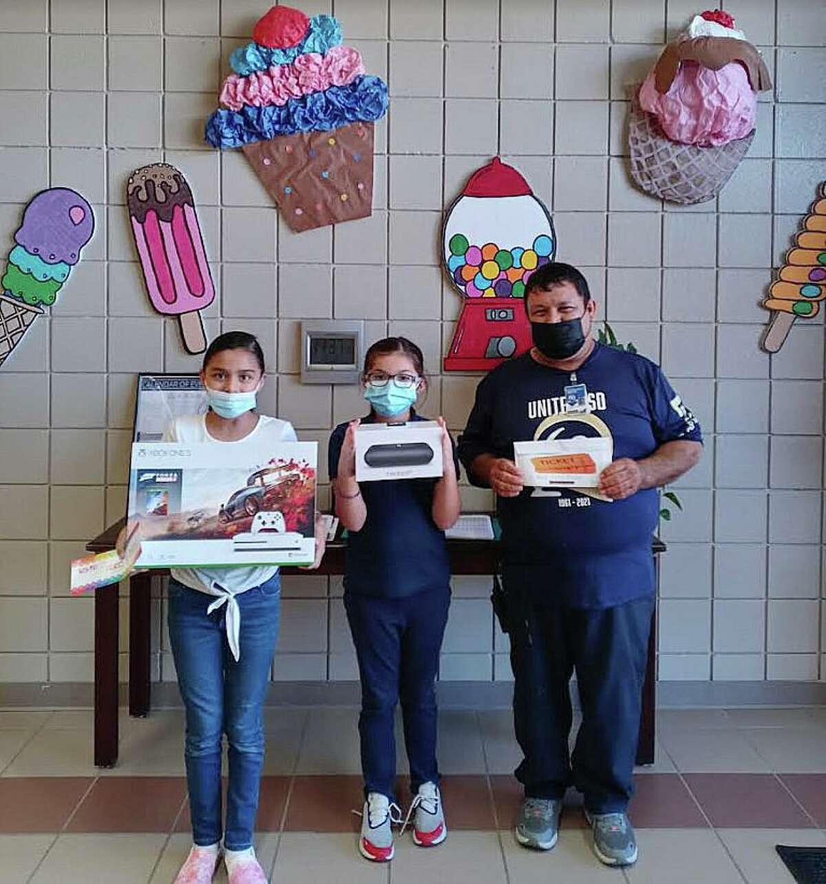 Pictured are Sophia Garza, Alexandria Rodriguez and Centeno Elementary School custodian Francisco Marquez.