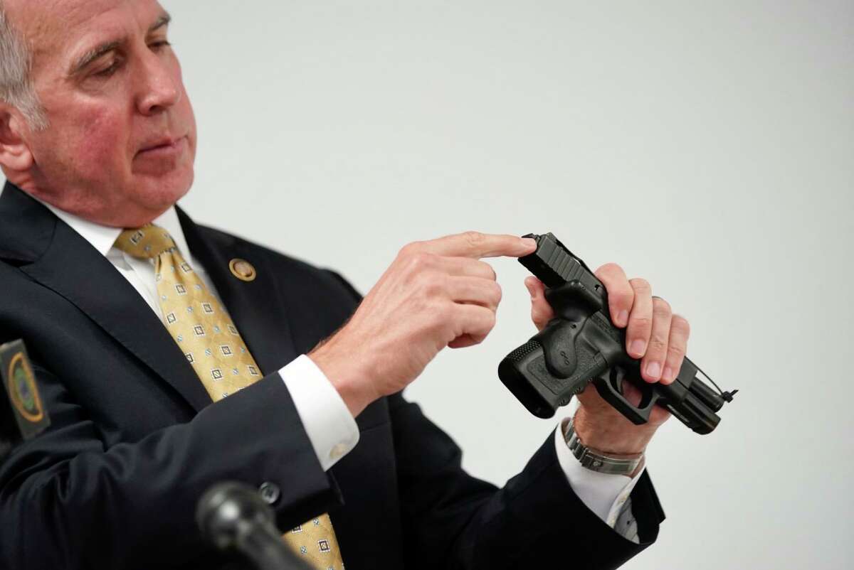Fred Milinowski, special agent in charge at ATF Houston Field Division, points at the device being used to convert handguns to operate fully automatic during a presentation after the release of body-worn camera footage from the fatal shooting on Sept. 20 of officer William Jeffrey, during a media briefing at the Houston Police Department headquarters in downtown Houston, Oct. 12, 2021.