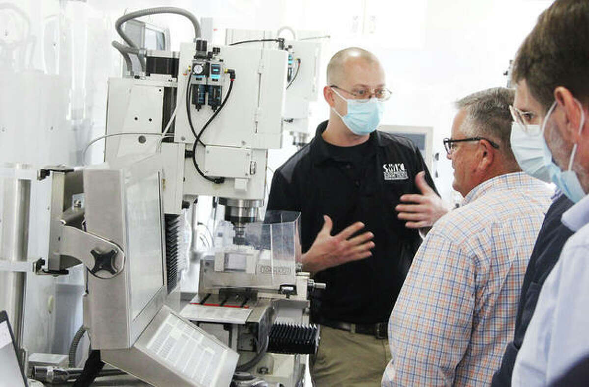 Jerry Bonifield, left, a faculty member at Southwestern Illinois College, gives people a tour of the school’s Advanced Mobile Manufacturing Lab during a Manufacturing Roundtable held Tuesday at Gatway Convention Center in Collinsville. The lab is used both as a promotional tool, and to assist students in local high schools with manufacturing projects. The roundtable was attended by about 50 people, including representatives of local manufacturing companies, schools and governments, and focused on creating a “pathway” for high school students interested in manufacturing careers.