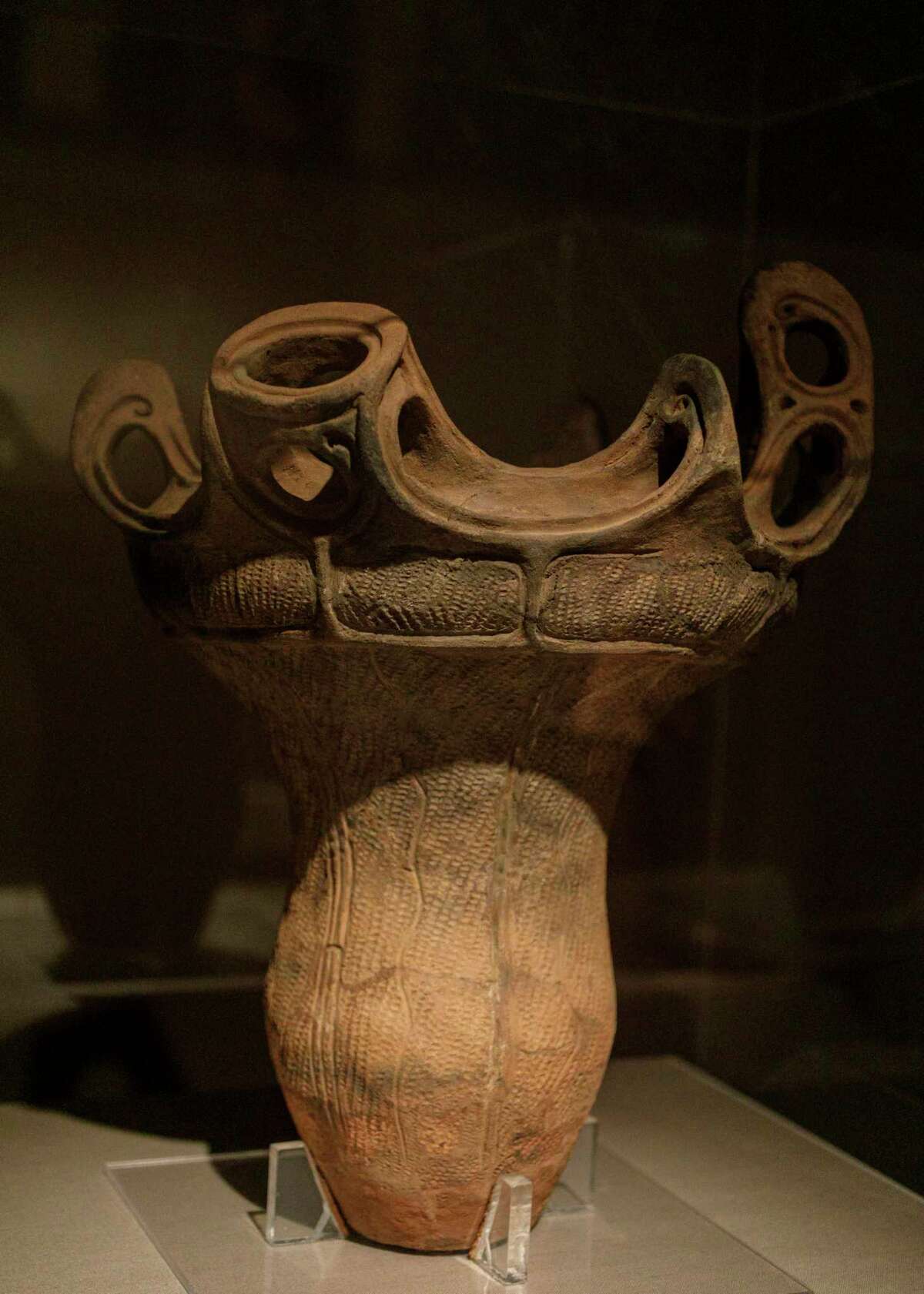 A Japanese earthenware jar from the Jomon Period, 3000-2000 BC, is on display for visitors to look at in the Japanese art gallery at the San Antonio Museum of Art in San Antonio, Texas, Friday, Oct. 1, 2021. The jar was purchased with funds provided by the Lenora and Walter F. Brown Asian Art Challenge Fund.