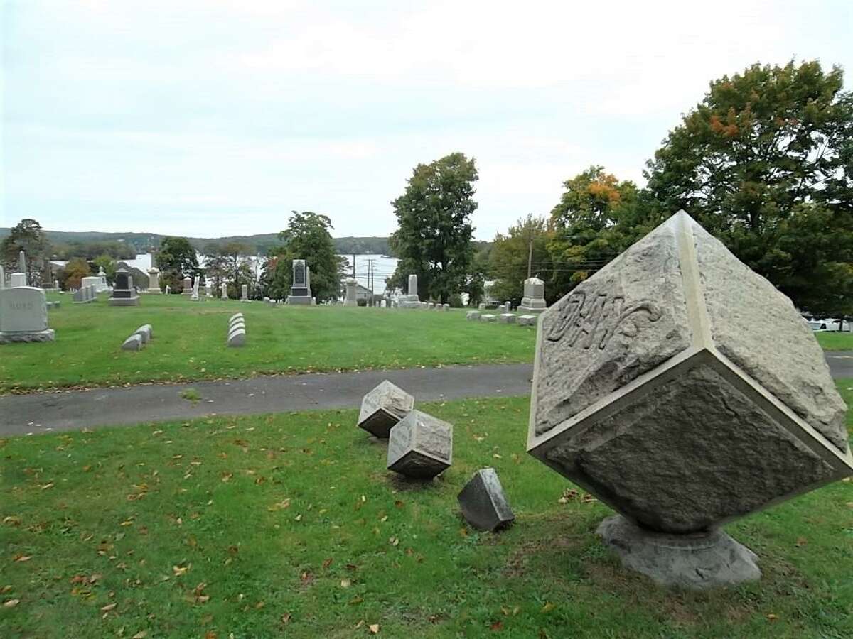 Shown here are gravestones at Lake View Cemetery in East Hampton, with Lake Pocotopaug in the background.