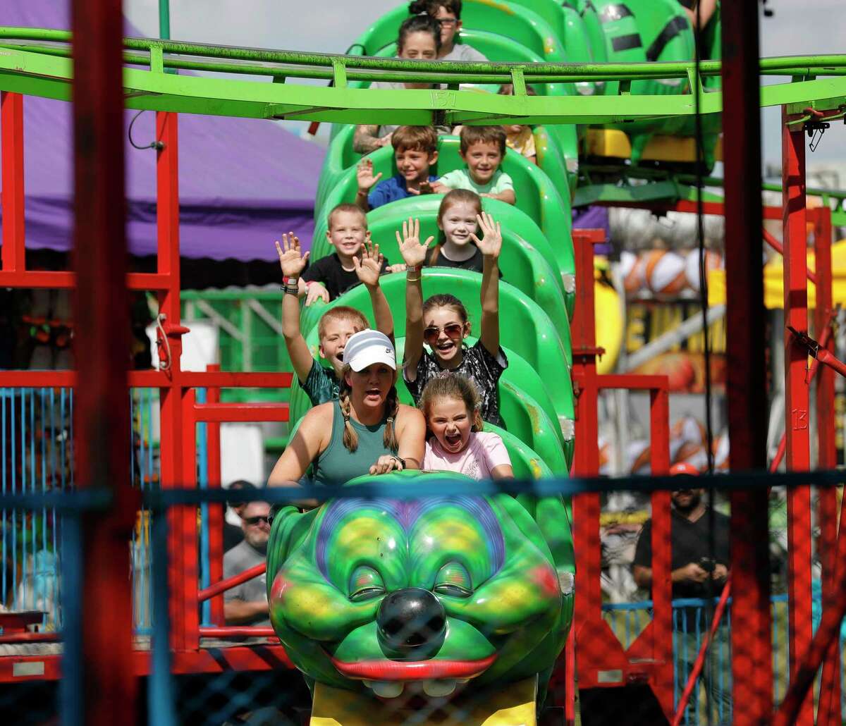 Sarah May, left, scream as she rides the Wacky Worm with her daughter, Eva, during the annual Conroe Cajun Catfish Festival, Saturday, Oct. 9, 2021, in Conroe.