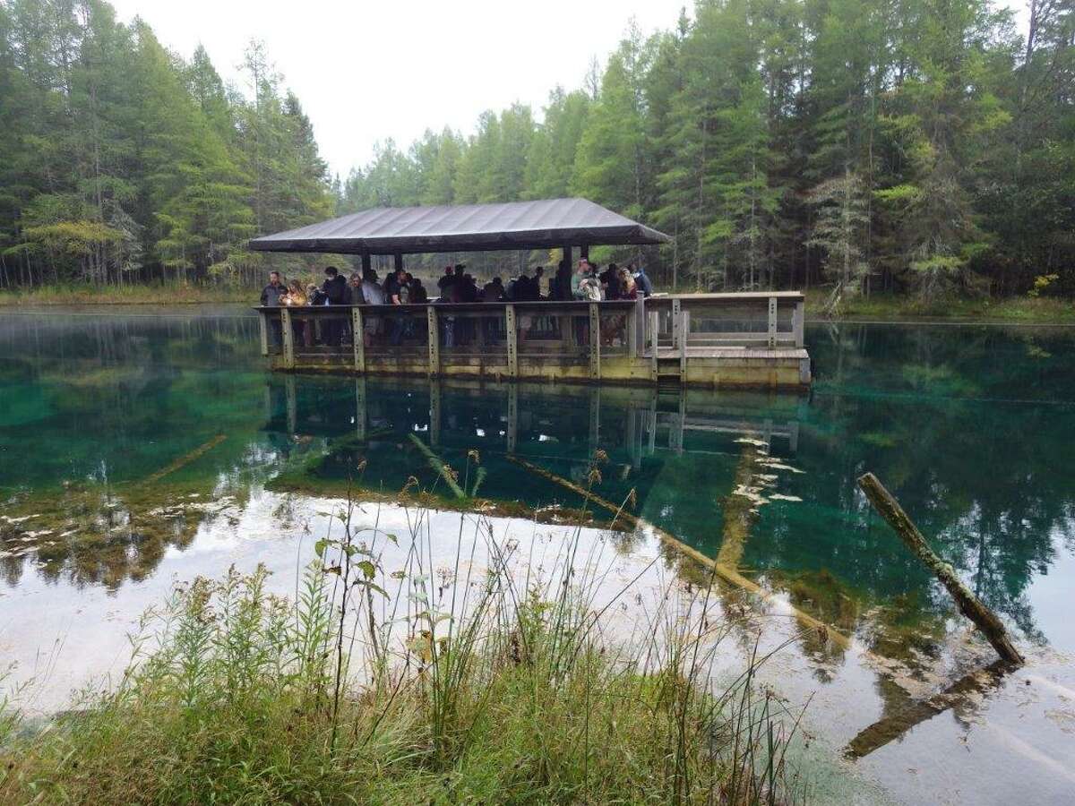 A large raft is used to take visitors over Kitch-iti-kipi, the Big Spring, to view the beautiful spring and its inhabitants in the crystal clear, 45-degree water. (Tom Lounsbury/Hearst Michigan)  