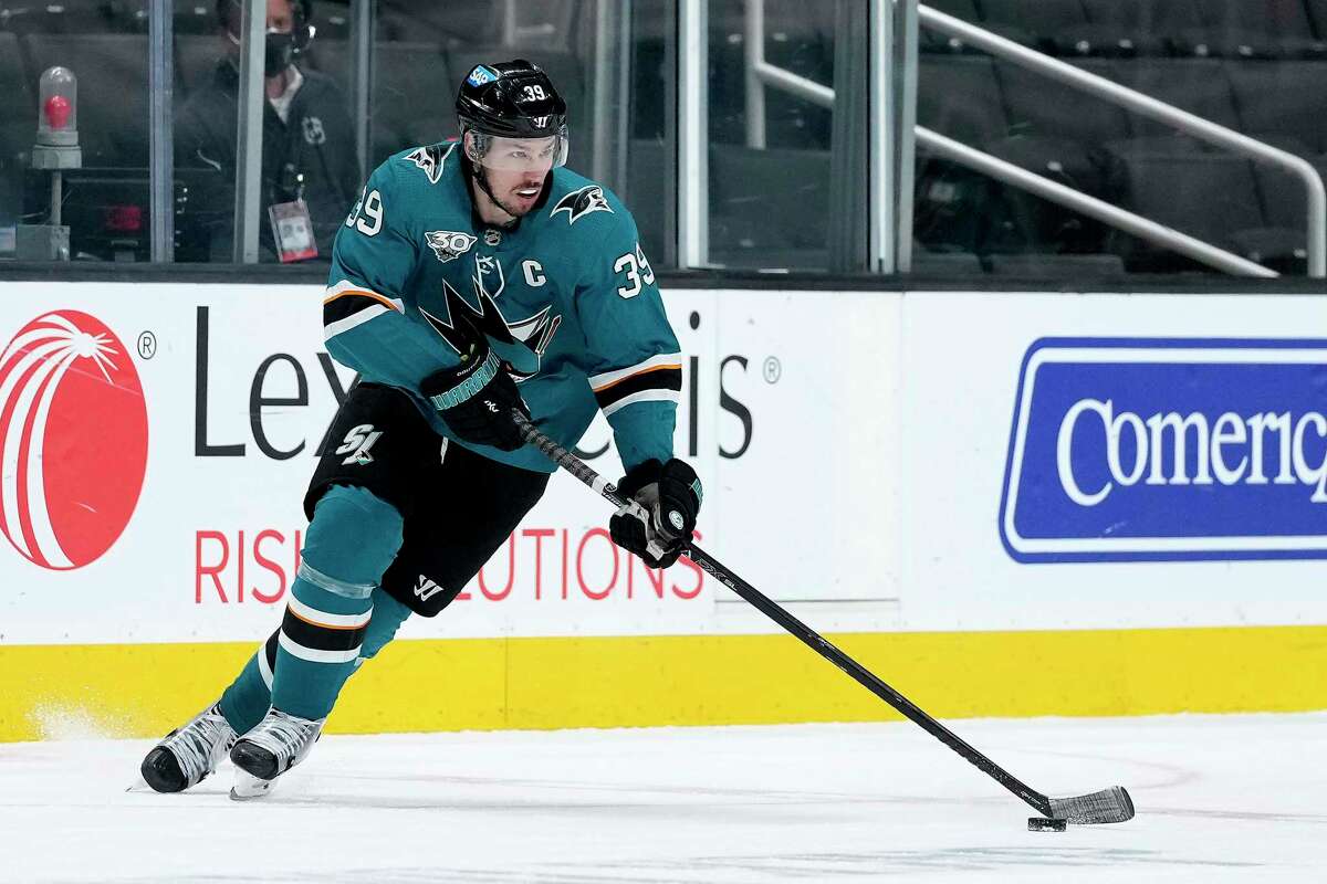San Jose Sharks center Logan Couture skates with the puck against the Anaheim Ducks during the third period of an NHL game April 13, 2021, in San Jose.
