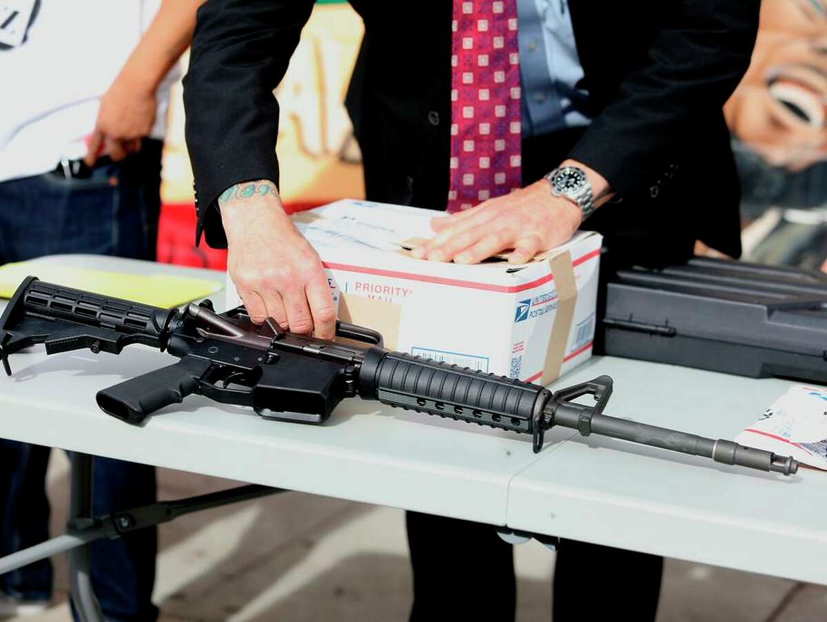 An inspector with the San Francisco District Attorney’s Office displays a ghost gun during a news conference at the United Playaz Violence Prevention Program on Tuesday.