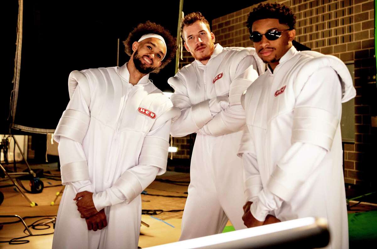Derrick White, from left, Jakob Poeltl and Keldon Johnson pose in space suits for a new round of the Spurs’ popular H-E-B commercials.