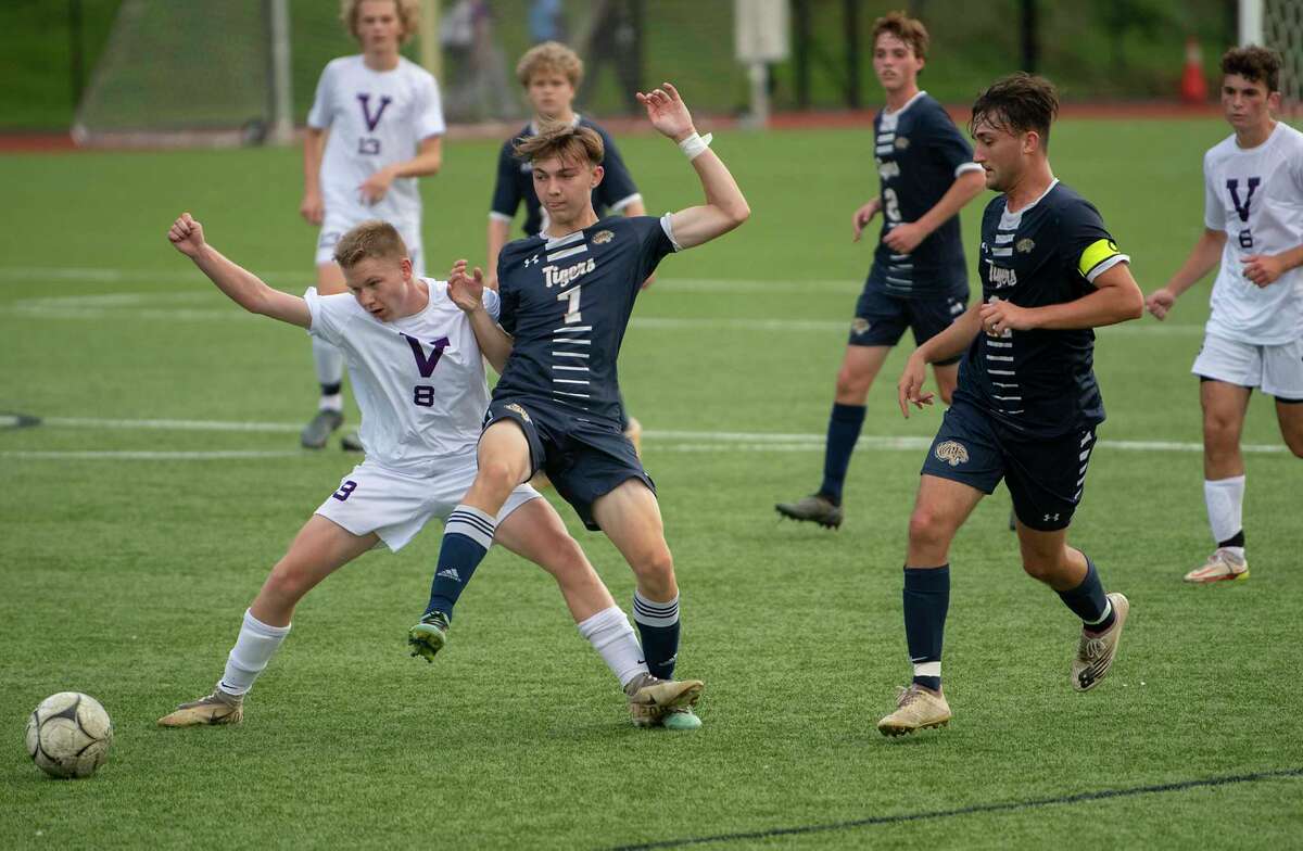 Voorheesville's Jake Johnson, left, battles for the ball with Cohoes' Zack Halloran during the Colonial Council tournament boys' soccer game on Wednesday, Oct, 13, 2021 in Troy, N.Y.