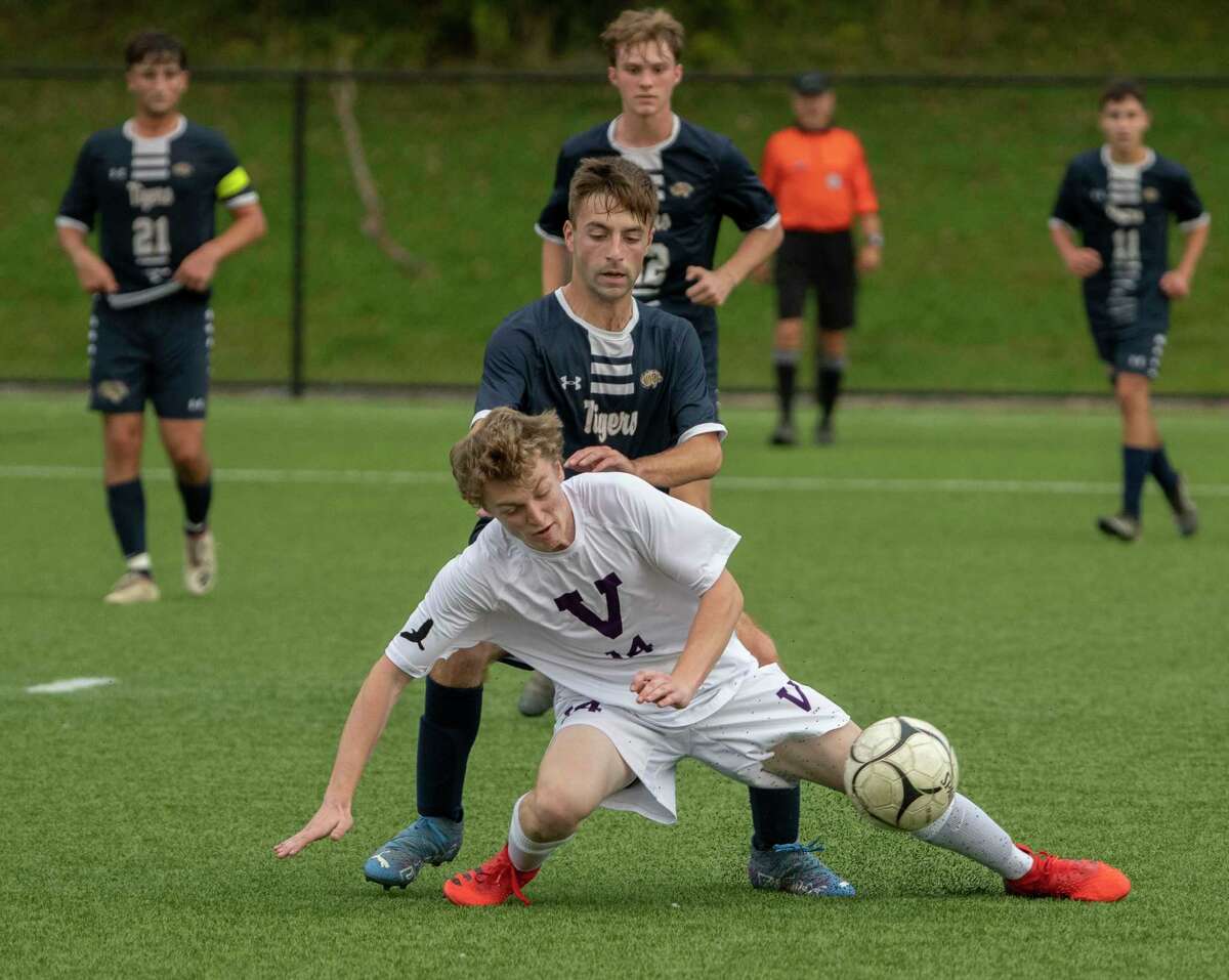 Cohoes' Luca Grestini battles for the ball with Voorheesville's Trevor Siemann, foreground, during the Colonial Council tournament boys' soccer game on Wednesday, Oct, 13, 2021 in Troy, N.Y.