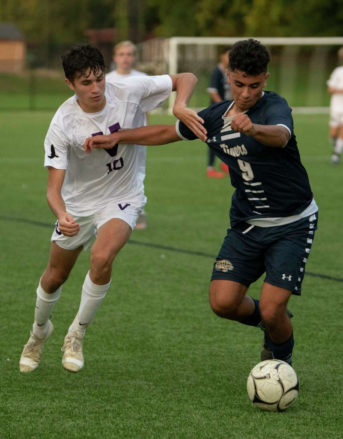 Voorheesville's Ryan McMillen, left, battles for the ball with Cohoes' Johnny Martinez-Peraza during the Colonial Council tournament boys' soccer game on Wednesday, Oct, 13, 2021 in Troy, N.Y.
