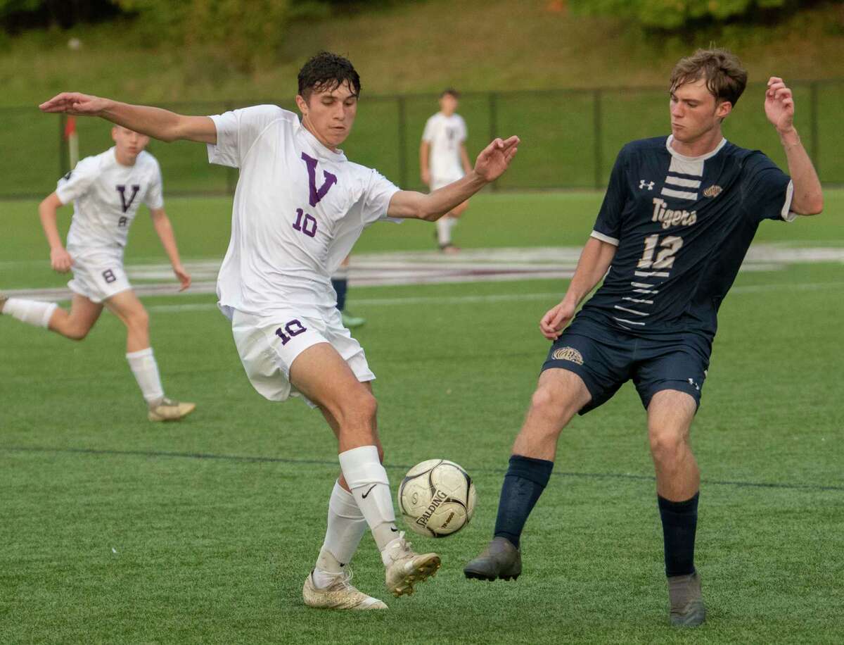 Voorheesville's Ryan McMillen, left, battles for the ball with Cohoes' Ryan Primeau during the Colonial Council tournament boys' soccer game on Wednesday, Oct, 13, 2021 in Troy, N.Y.