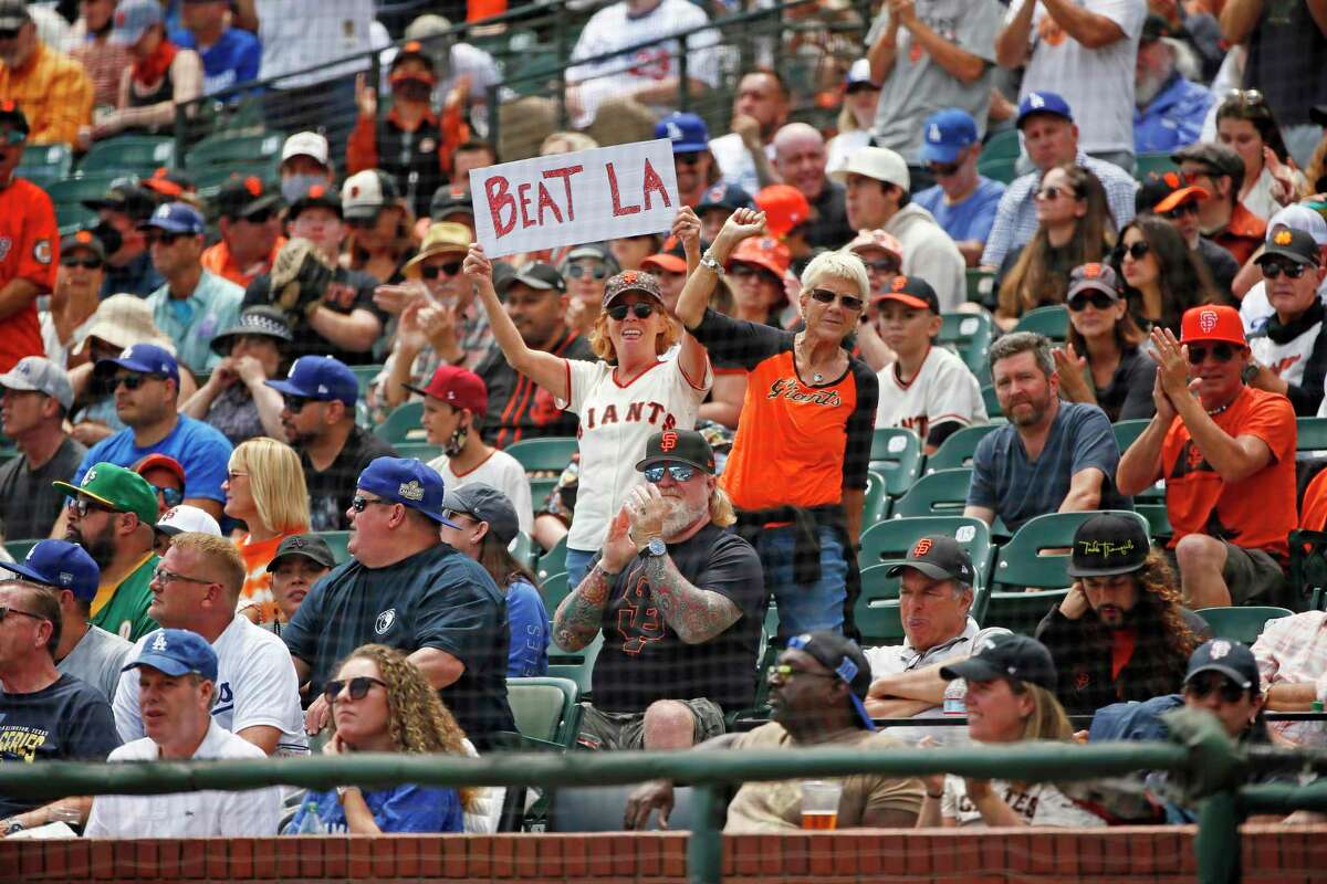 Spectators cheer in the first inning at Oracle Park during a July 2021 game between the S.F. Giants and longtime rival L.A. Dodgers. Most fans are unmasked, but their sentiments toward the Southern California team are unmistakable.