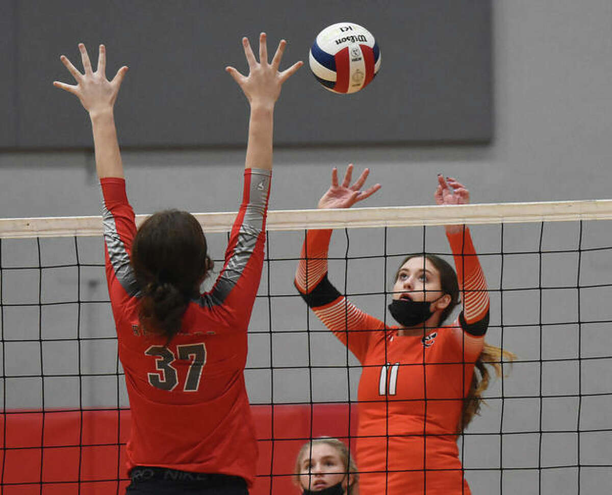Edwardsville’s Gabby Saye pushes the ball over the net during the first set against the Alton Redbirds on Tuesday in Alton.