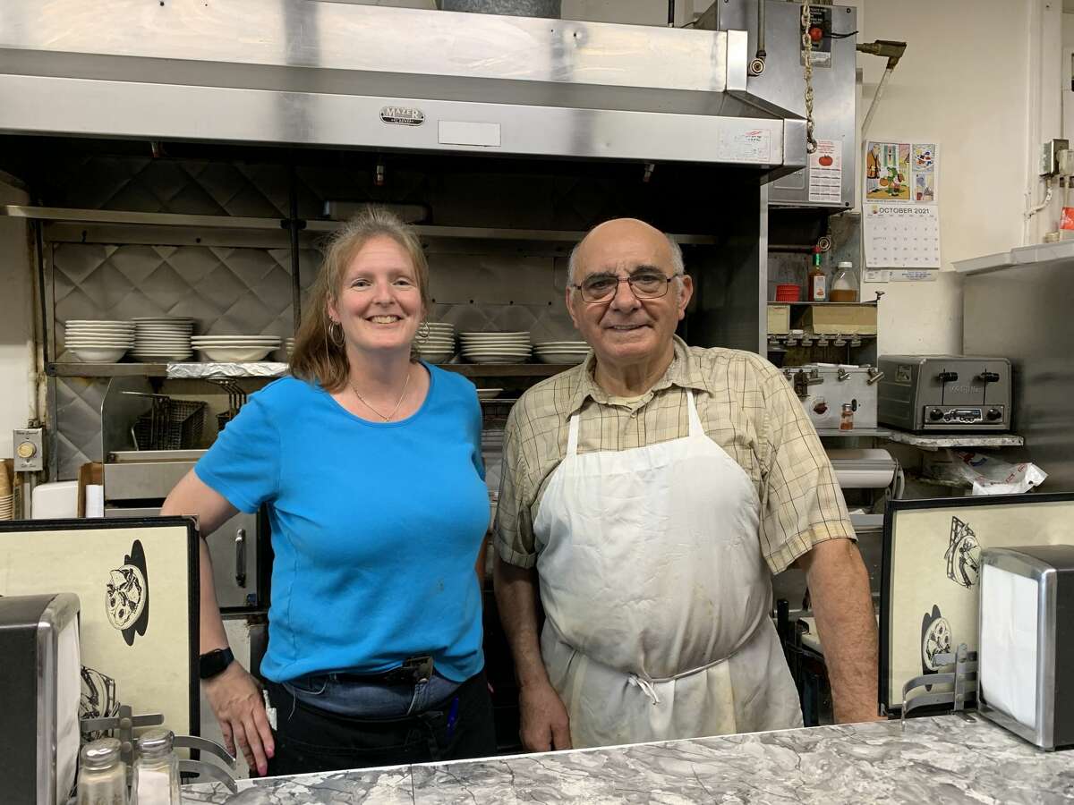 John Puglisi, right, took over the Big Tomato on Main Street in Poughkeepsie over 40 years ago. Today, it often sees a full house, with long-time waitresses like Amanda Dalbo, left, serving both regulars and out-of-towners.