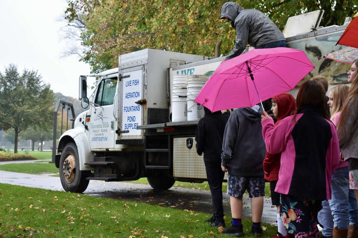 On Oct. 14, students from Big Rapids Middle School helped Harrietta Hills Trout Farm release young fish into the Muskegon River using buckets.