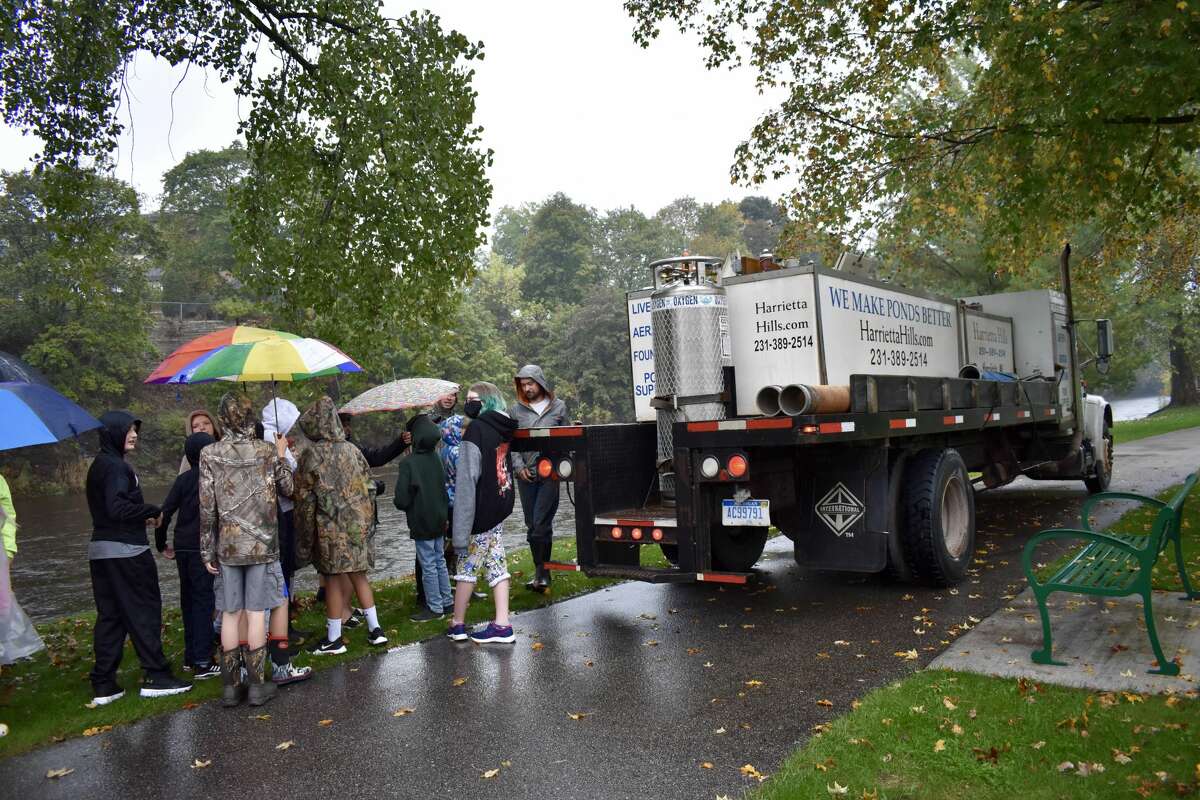 On Oct. 14, students from Big Rapids Middle School helped Harrietta Hills Trout Farm release young fish into the Muskegon River using buckets.