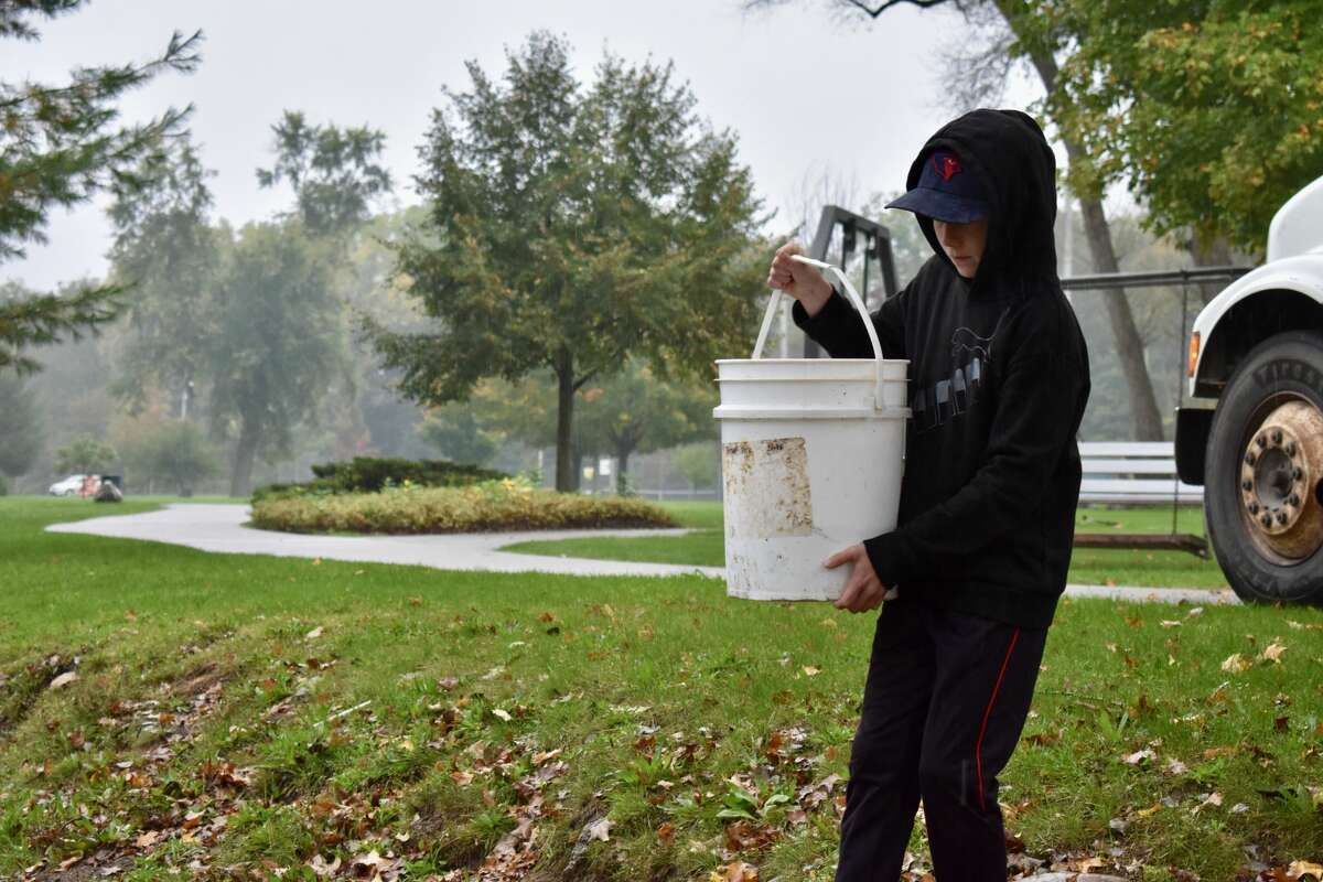 On Oct. 14, students from Big Rapids Middle School helped Harrietta Hills Trout Farm release young fish into the Muskegon River using buckets.
