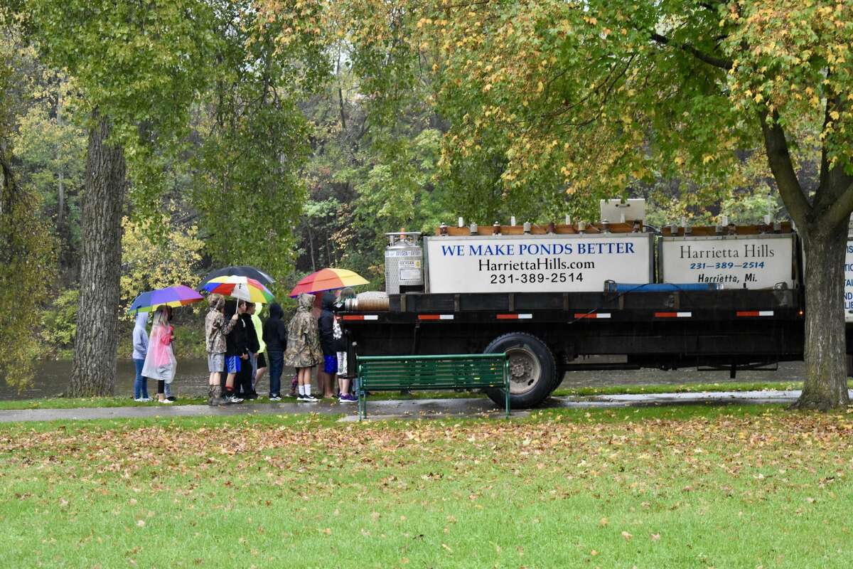 On Oct. 14, students from Big Rapids Middle School helped Harrietta Hills Trout Farm release young fish into the Muskegon River using buckets.