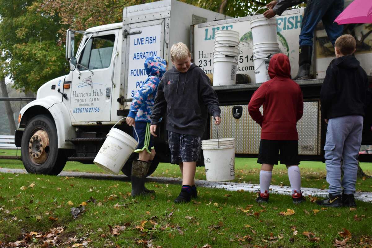 On Oct. 14, students from Big Rapids Middle School helped Harrietta Hills Trout Farm release young fish into the Muskegon River using buckets. 