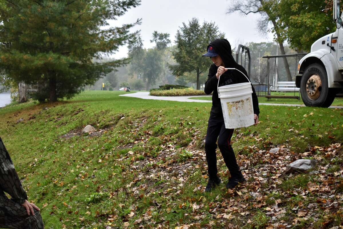 On Oct. 14, students from Big Rapids Middle School helped Harrietta Hills Trout Farm release young fish into the Muskegon River using buckets.