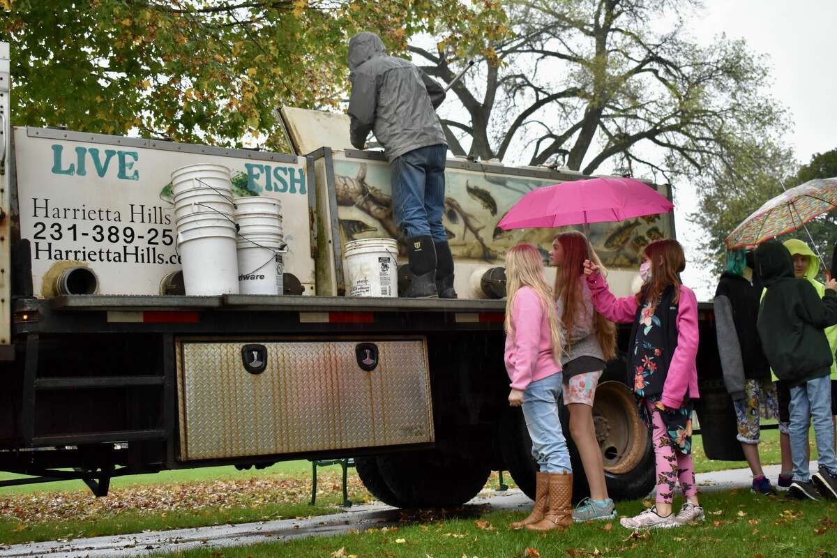 On Oct. 14, students from Big Rapids Middle School helped Harrietta Hills Trout Farm release young fish into the Muskegon River using buckets.