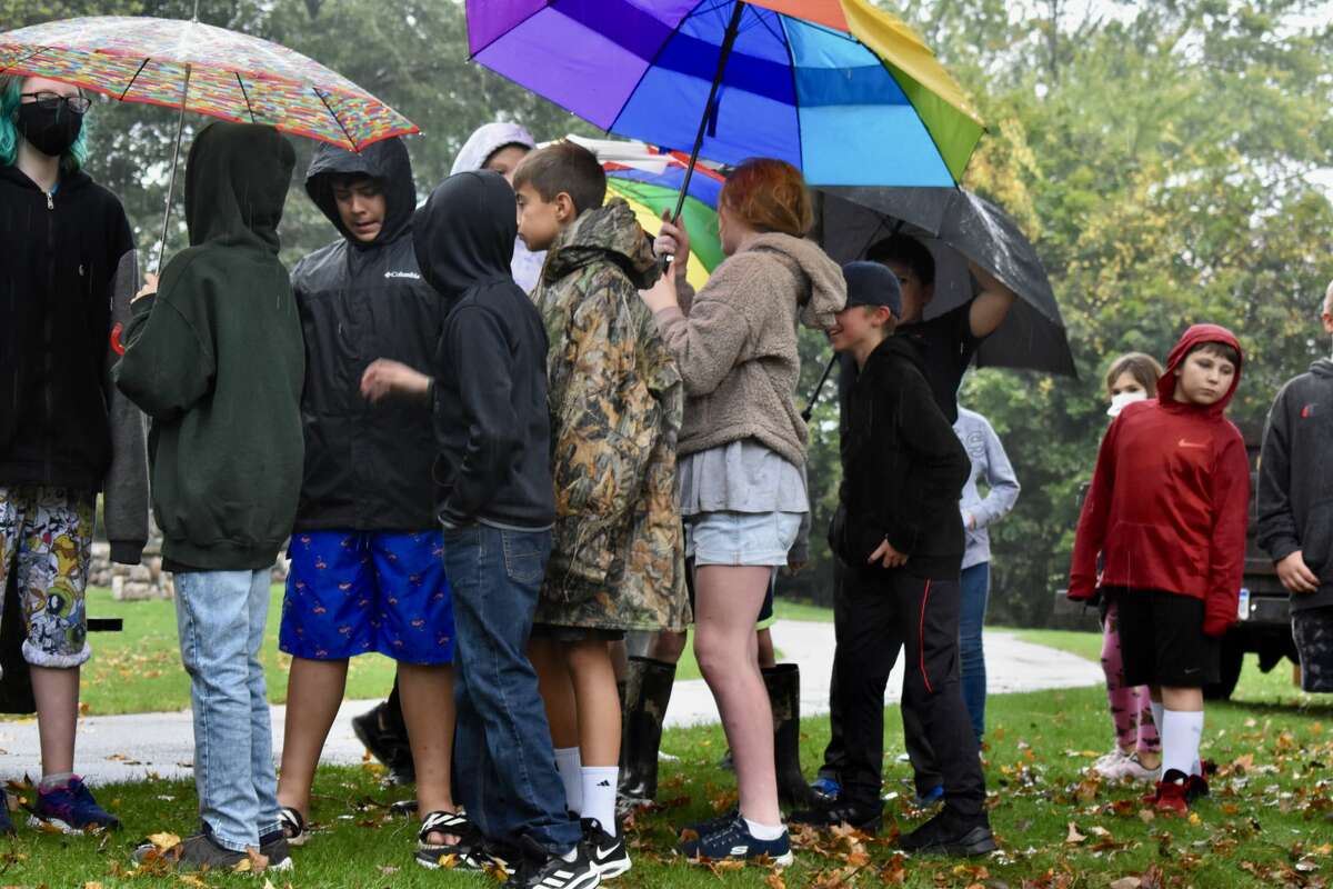 On Oct. 14, students from Big Rapids Middle School helped Harrietta Hills Trout Farm release young fish into the Muskegon River using buckets.
