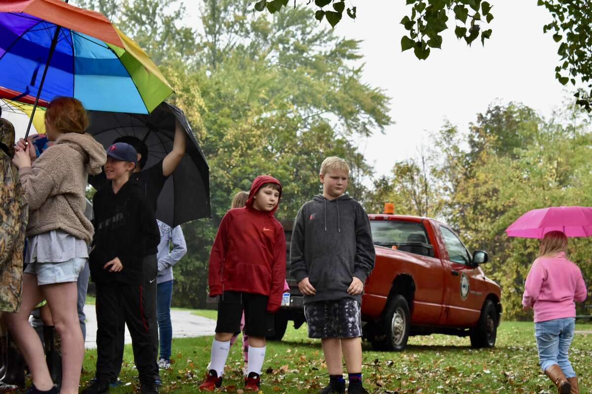 On Oct. 14, students from Big Rapids Middle School helped Harrietta Hills Trout Farm release young fish into the Muskegon River using buckets.