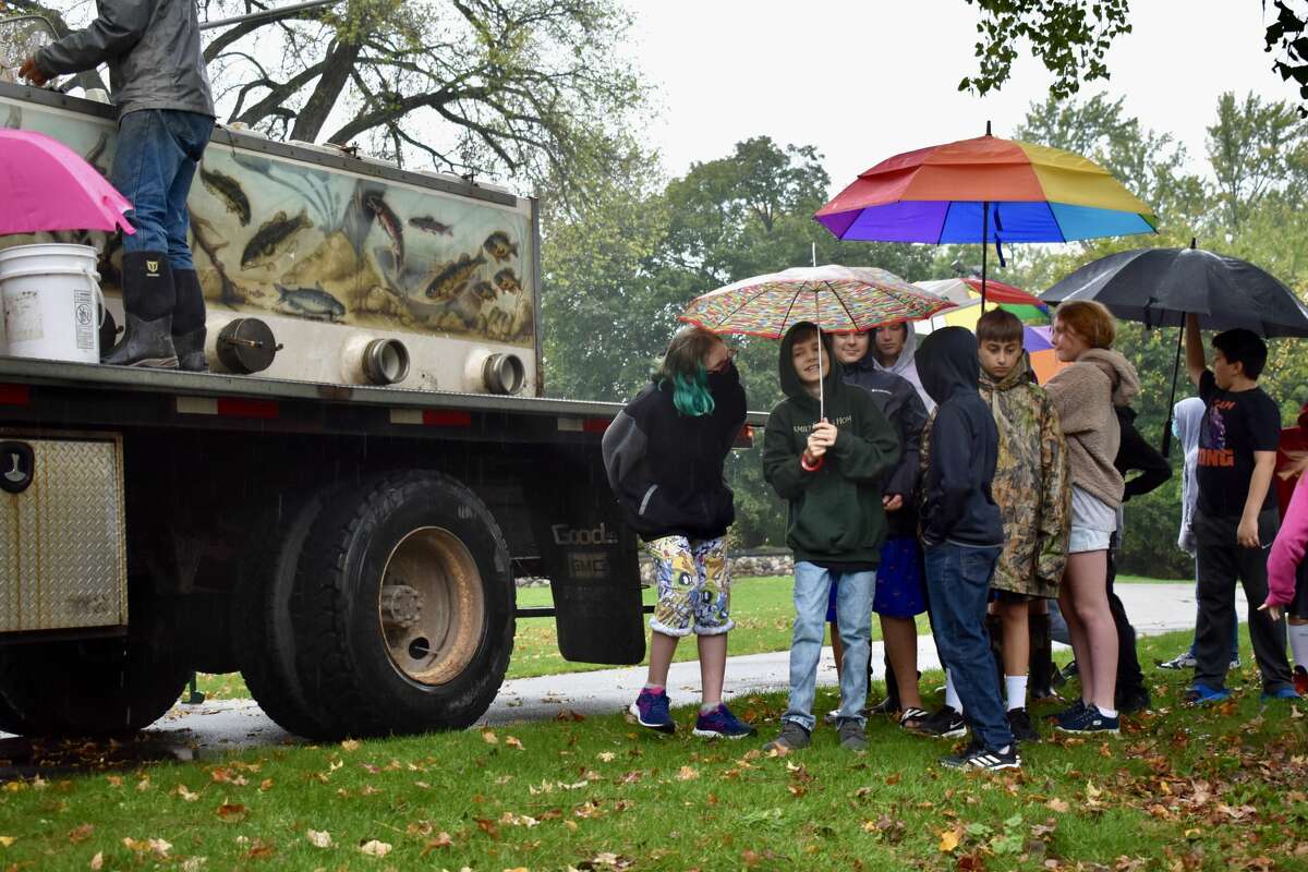 On Oct. 14, students from Big Rapids Middle School helped Harrietta Hills Trout Farm release young fish into the Muskegon River using buckets.