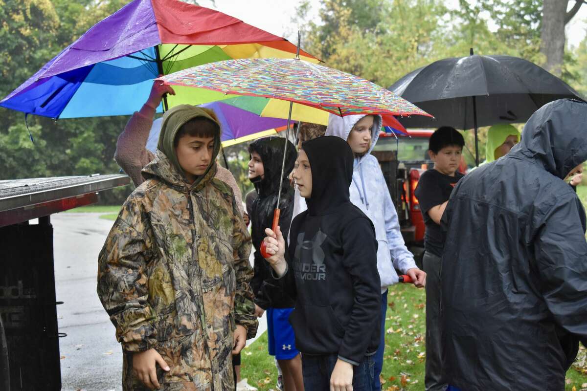 On Oct. 14, students from Big Rapids Middle School helped Harrietta Hills Trout Farm release young fish into the Muskegon River using buckets.