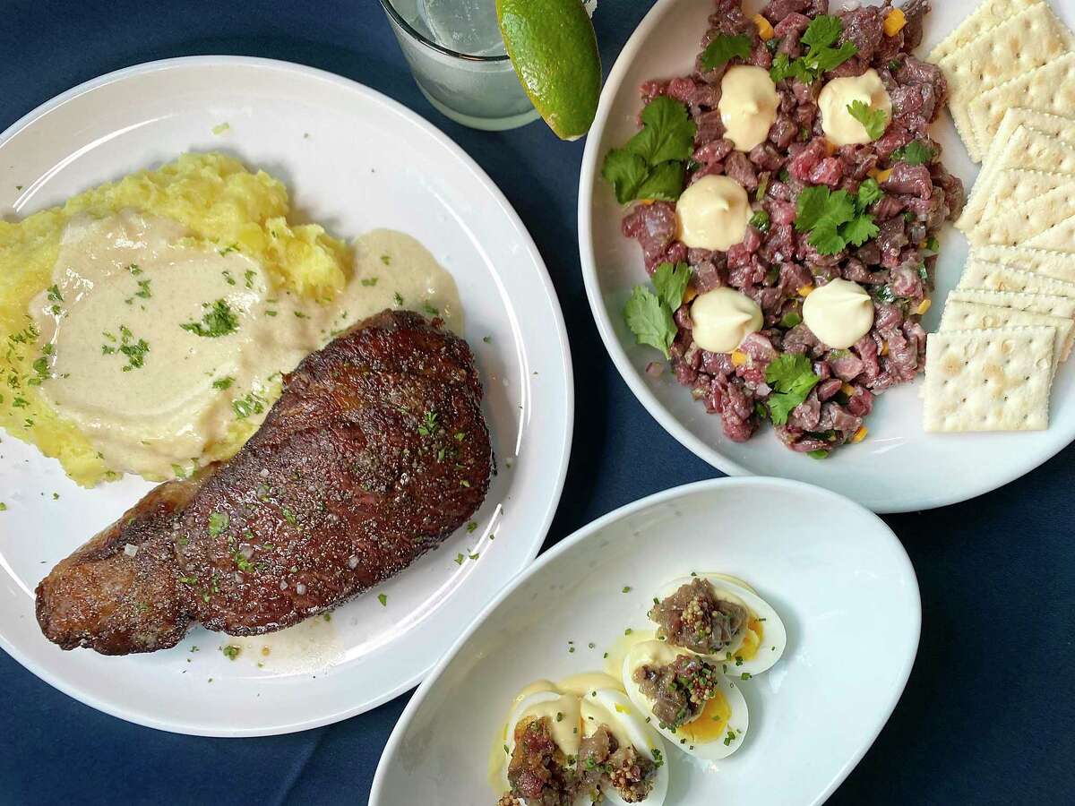 The Range at the Embassy Suites by Hilton San Antonio Riverwalk Downtown menu includes, clockwise from left, cast-iron seared rib eye, margarita, parisa beef tartare and eggs stuffed with breast jam.