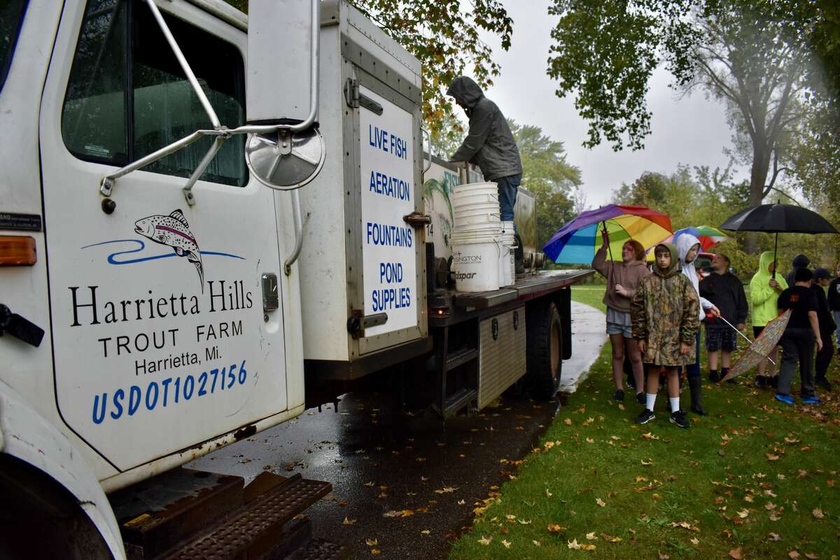 On Oct. 14, students from Big Rapids Middle School helped Harrietta Hills Trout Farm release young fish into the Muskegon River using buckets.