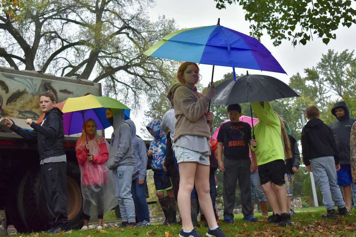 On Oct. 14, students from Big Rapids Middle School helped Harrietta Hills Trout Farm release young fish into the Muskegon River using buckets.