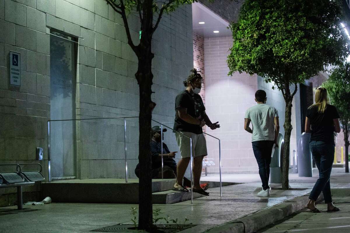 People walk out of the Harris County Jail after being released, Friday, Oct. 8, 2021, in Houston.