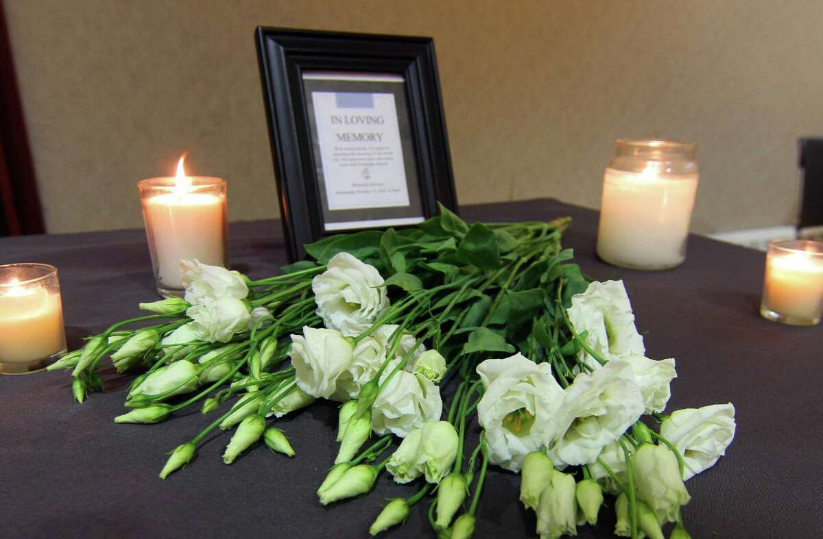 A station representing a memorial for a victim of domestic violence is set up at YWCA Greenwich's In Their Shoes event to mark Domestic Violence Awareness Month in Greenwich, Conn., on Wednesday October 13, 2021. The event allows people to walk in the shoes of people experiencing abusive and controlling relationships. Attendees paired up and each chose a colored card, which took them to various stations set up to represent scenarios that victims of domestic abuse go through, like child custody, an abuse shelter, therapy or court, among others.