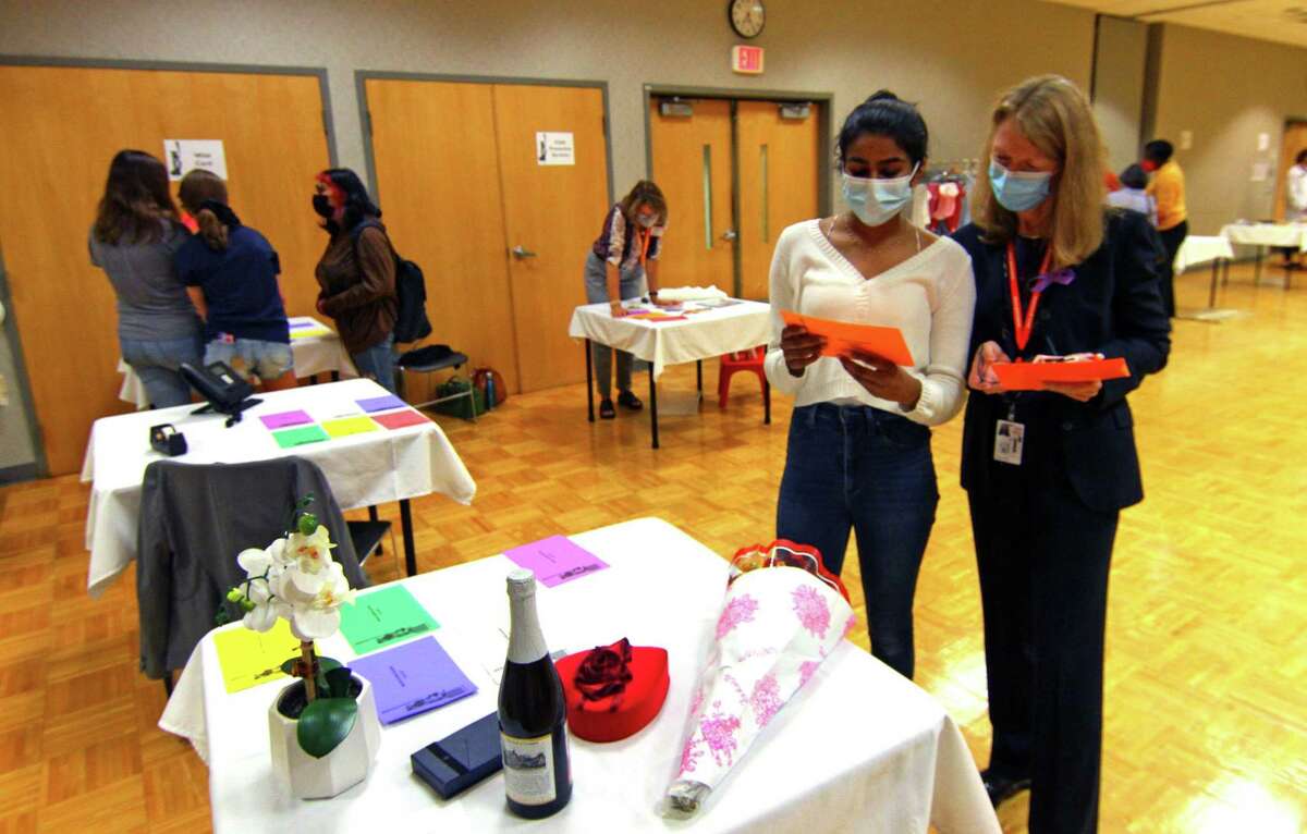 YWCA Greenwich holds its In Their Shoes event to mark Domestic Violence Awareness Month in Greenwich, Conn., on Wednesday October 13, 2021. The event allows people to walk in the shoes of people experiencing abusive and controlling relationships. Attendees paired up and each chose a colored card, which took them to various stations set up to represent scenarios that victims of domestic abuse go through, like child custody, an abuse shelter, therapy or court, among others.