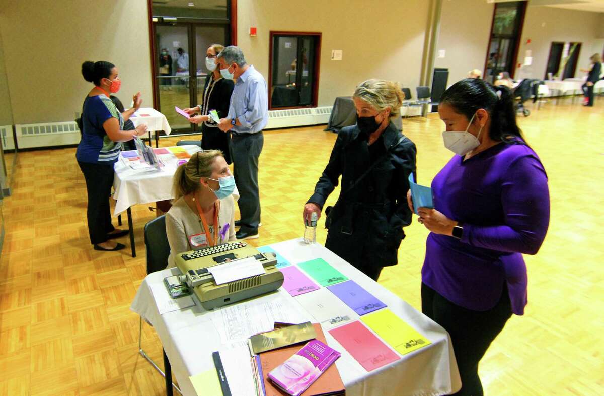 YWCA Greenwich holds its In Their Shoes event to mark Domestic Violence Awareness Month in Greenwich, Conn., on Wednesday October 13, 2021. The event allows people to walk in the shoes of people experiencing abusive and controlling relationships. Attendees paired up and each chose a colored card, which took them to various stations set up to represent scenarios that victims of domestic abuse go through, like child custody, an abuse shelter, therapy or court, among others.