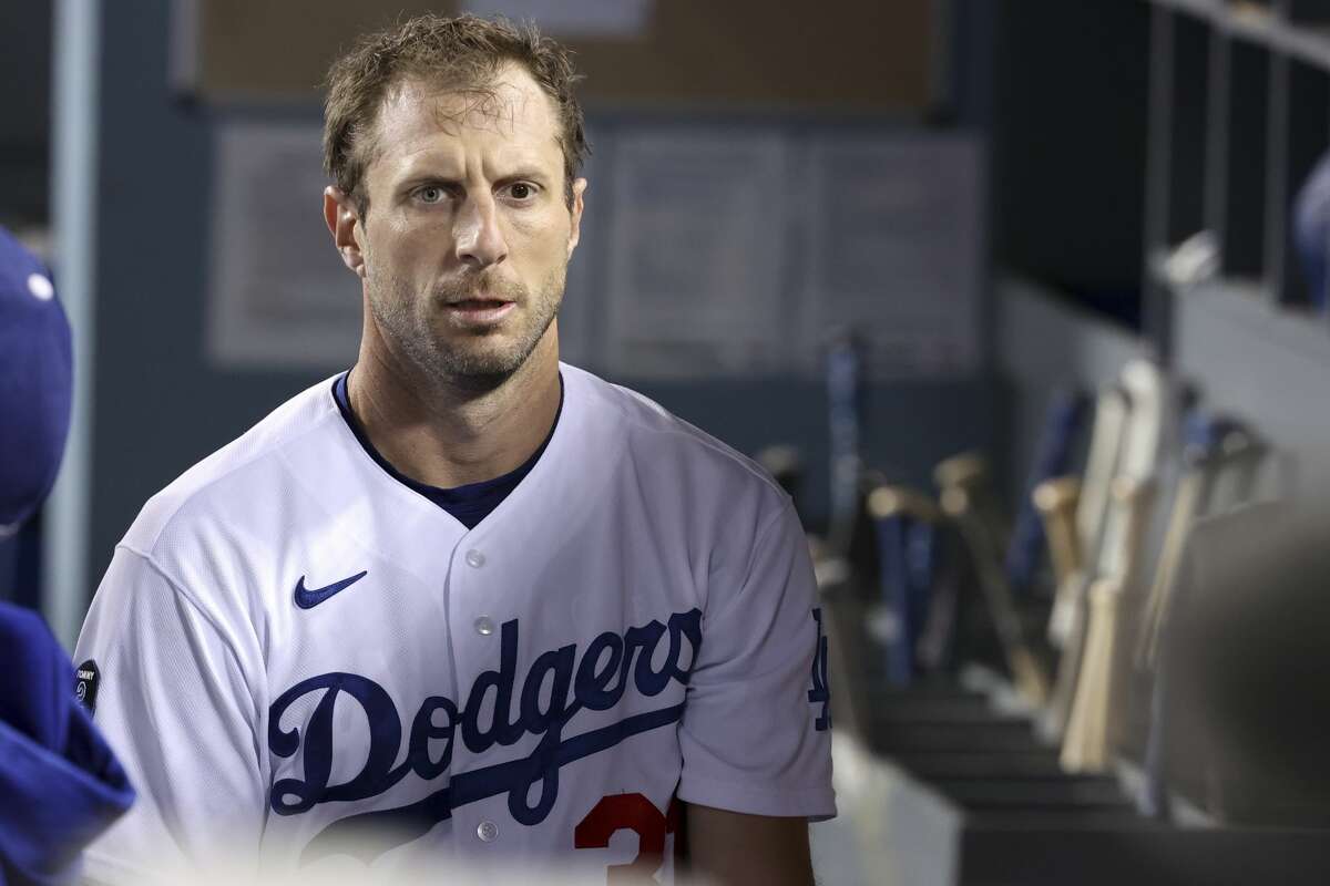 Los Angeles Dodgers starting pitcher Max Scherzer walks in the dugout in game three of the 2021 NLDS against the San Francisco Giants at Dodger Stadium on Monday, Oct. 11, 2021.