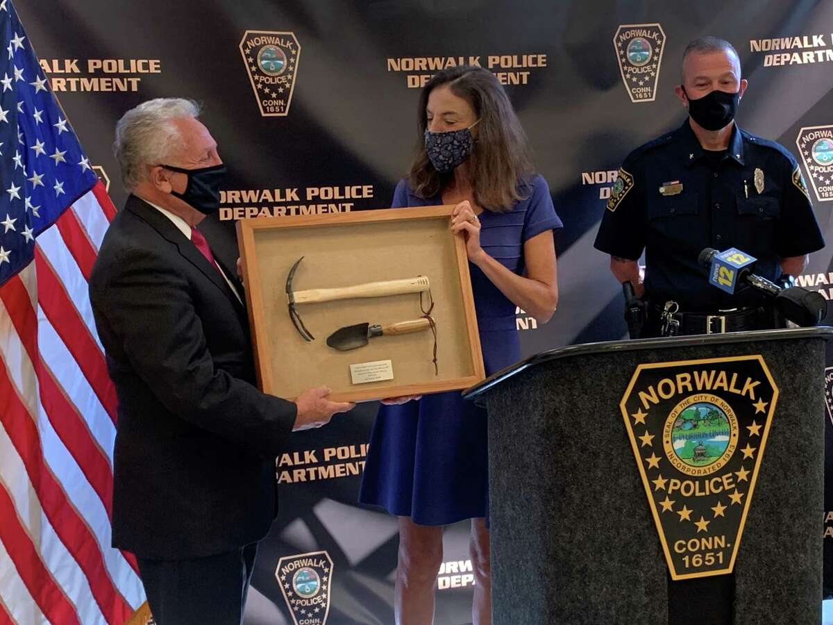 Mayor Harry Rilling joined members for the Norwalk Police Department and Wilton Quaker Meeting members Peter Murchison and Diane Keefe to announce Saturday's community gun buyback event in Norwalk on Thursday, Oct. 14 at the Norwalk Police station. Rilling was presented with two gardening tools forged from guns collected during the 2019 buyback.