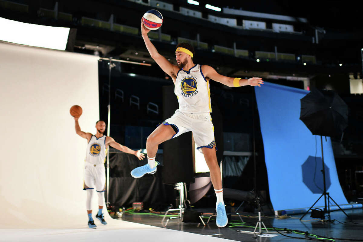 Golden State Warriors guard Klay Thompson photobombs teammate Stephen Curry during his photo session at media day at Chase Center in San Francisco, Calif., on Friday, May 21, 2021.
