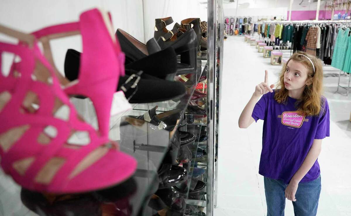 Social Motion Skills student Harmony Kelley, 15, looks for shoes that need to be reorganized during the “Learn to Work” program in August at Designer Diva. Social Motion and Designer Diva are partnering to train neurodiverse teens and young adults on transition-to-work skills.