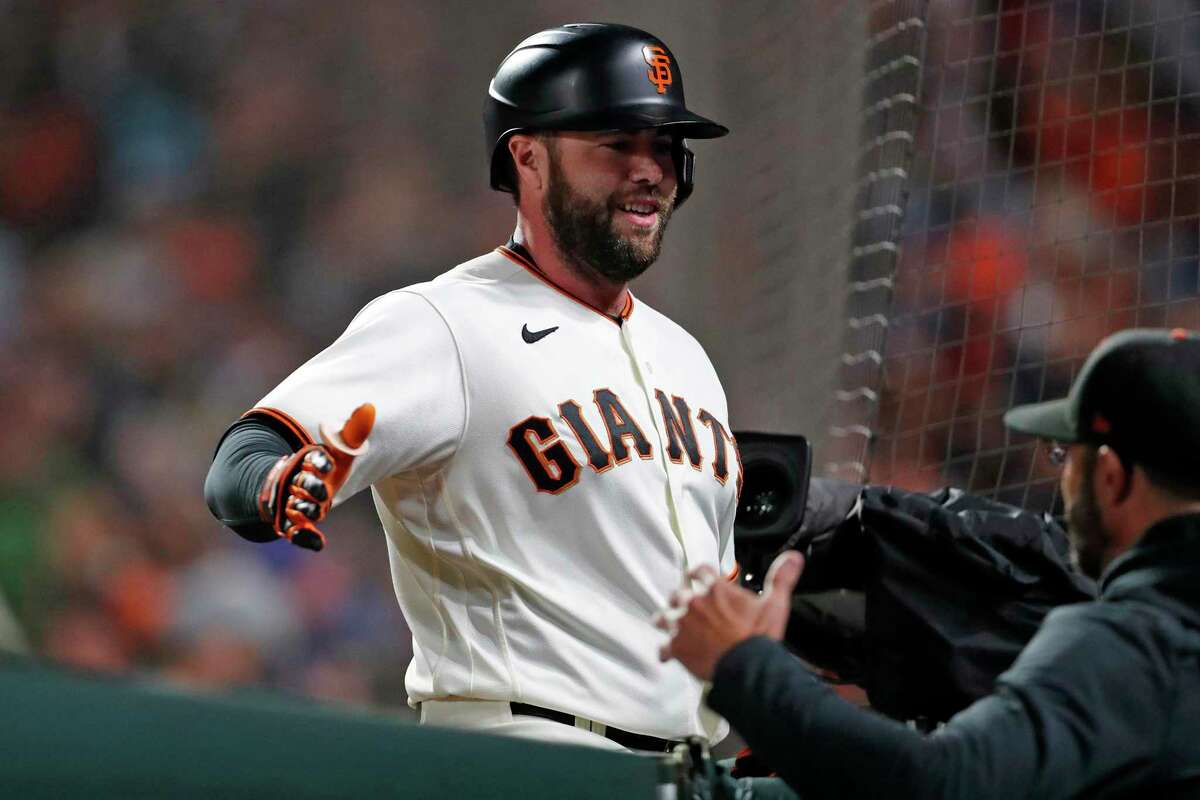 San Francisco Giants' Darin Ruf returns to dugout after solo home run in 6th inning against Los Angeles Dodgers during NLDS Game 5 at Oracle Park in San Francisco, Calif., on Thursday, October 14, 2021.
