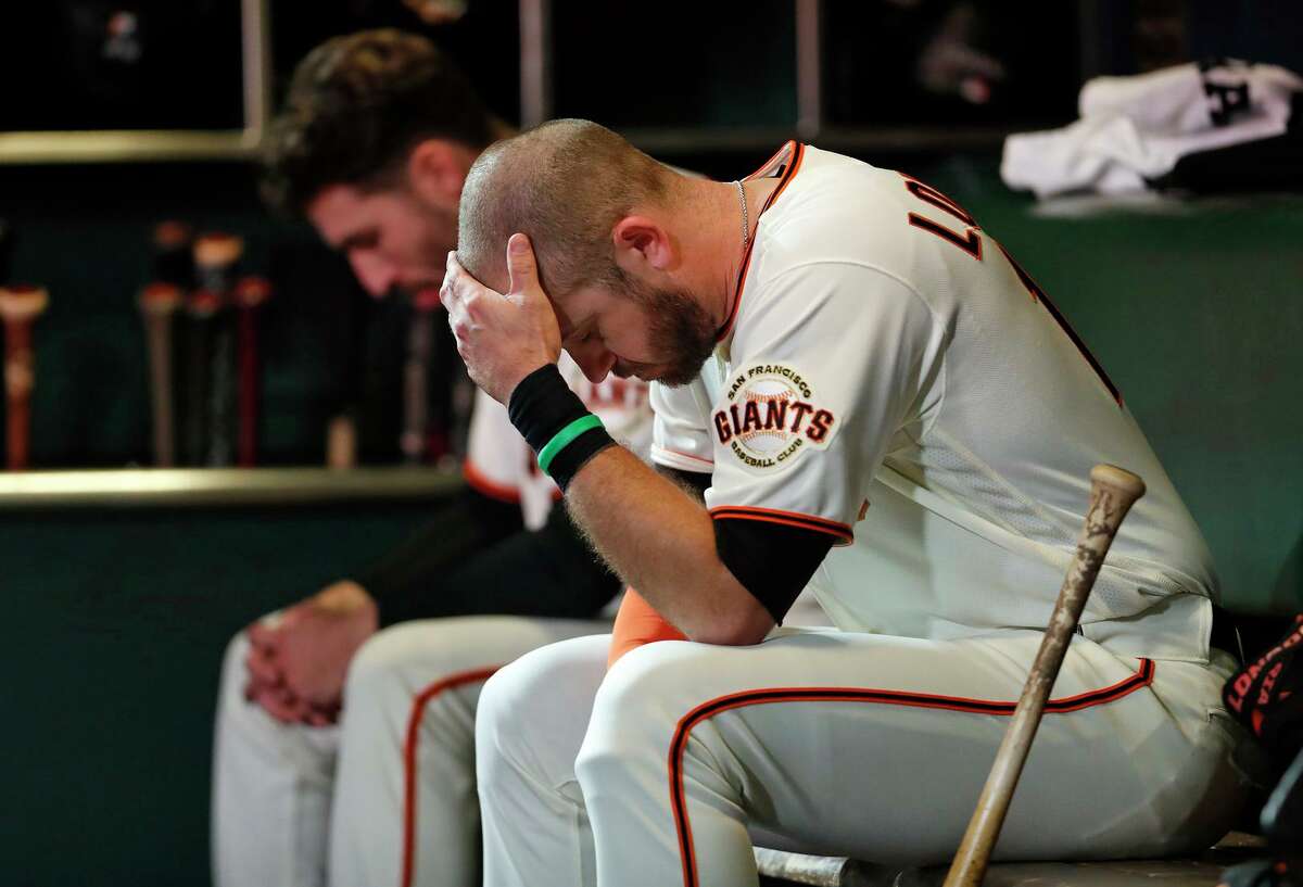 San Francisco Giants' Evan Longoria sits in dugout after 2-1 loss to Los Angeles Dodgers in NLDS Game 5 at Oracle Park in San Francisco, Calif., on Thursday, October 14, 2021.
